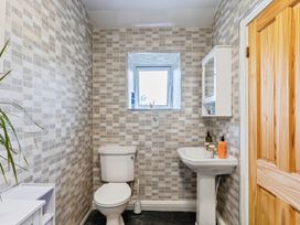 A bathroom with a toilet and sink at Rivendell in Ffynnongroyw