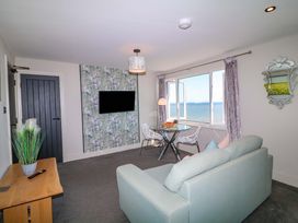 A living room with a sofa and dining table at Apt 7 @ Hunter's Quay in Bridlington