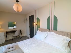 A bedroom with a bed and desk at Apt 7 @ Hunter's Quay Bridlington