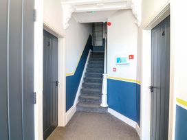 A hallway with doors and a staircase at Apt 7 @ Hunter's Quay Bridlington