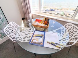 A dining room with a glass table and chairs at Apt 7 @ Hunter's Quay Bridlington