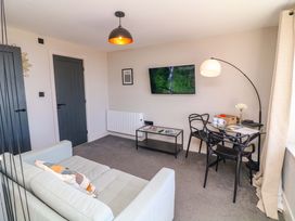 A living room with a sofa and television at Apt 8 @ Hunter's Quay in Bridlington