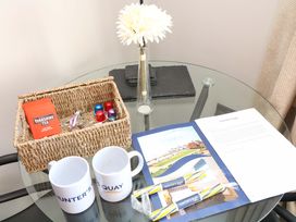 A living room with a tea basket and mugs at Apt 8 @ Hunter's Quay, Bridlington