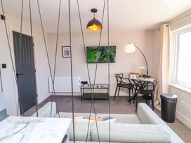 A living room with a television and a dining table at Apt 8 @ Hunter's Quay, Bridlington