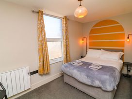A bedroom with a bed and bedside table at Apt 8 @ Hunter's Quay, Bridlington