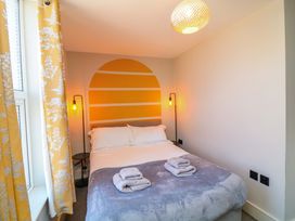 A bedroom with a bed and lamps at Apt 8 @ Hunter's Quay, Bridlington