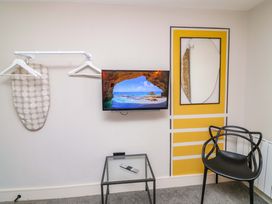 A bedroom with a television and an iron board at Apt 8 @ Hunter's Quay Bridlington