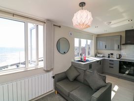 A living room with a sofa and kitchen unit at Apt 9 @ Hunter's Quay in Bridlington
