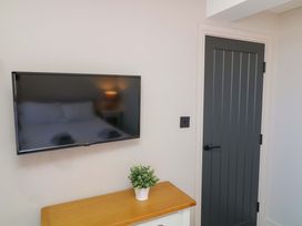 A bedroom with a television and a door at Apt 9 @ Hunter's Quay, Bridlington