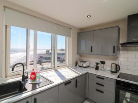 A kitchen with a sink and kitchen appliances at Apt 9 @ Hunter's Quay Bridlington