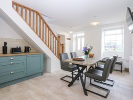 A dining room with a table and chairs at Trefor Ganol in Beaumaris