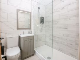 A bathroom with a shower, sink, and toilet at Trefor Ganol in Beaumaris