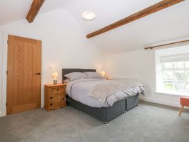 A bedroom with a bed and bedside table at Trefor Ganol in Beaumaris
