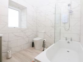 A bathroom with a bathtub, toilet, and shower at Trefor Ganol in Beaumaris