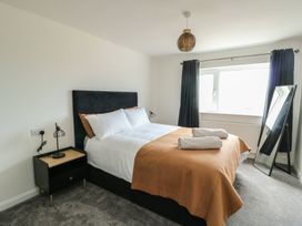 A bedroom with a bed and bedside table at 6 Gwelfor Estate