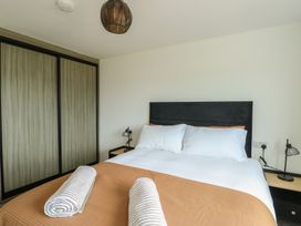 A bedroom with a bed and wardrobe at 6 Gwelfor Estate