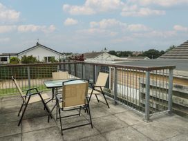 An outdoor seating area with a table and chairs at 6 Gwelfor Estate