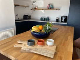 A kitchen with a fruit bowl and kitchen appliances at 6 Gwelfor Estate in Cemaes Bay