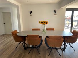 A dining room with a table and chairs at 6 Gwelfor Estate Cemaes Bay