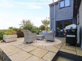 An outdoor area with seating and a grill at Tyn Rallt Newborough