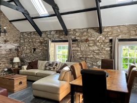 A living room with a sofa and dining table at Glas y Dorlan Nevern near Newport, Pembrokeshire