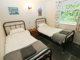A bedroom with two single beds and a window at Glas y Dorlan Nevern near Newport, Pembrokeshire