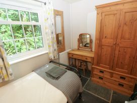 A bedroom with a bed and a wardrobe at Glas y Dorlan Nevern near Newport, Pembrokeshire