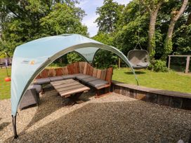 An outdoor seating area with a canopy and swing at Glas y Dorlan, Nevern near Newport, Pembrokeshire