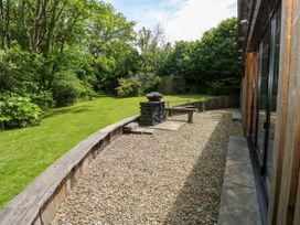 A garden with gravel, grass, a table and a barbecue at Glas y Dorlan Nevern near Newport, Pembrokeshire