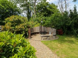 A garden with a fire pit surrounded by benches at Glas y Dorlan in Nevern near Newport, Pembrokeshire