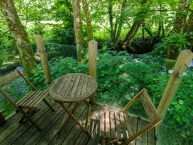 A wooden table and chairs in an outdoor seating area at Glas y Dorlan, Nevern near Newport, Pembrokeshire