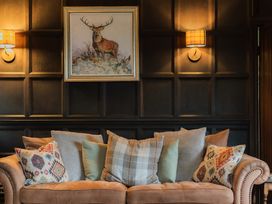 A living room with a sofa and cushions at Grey Walls in Glenridding