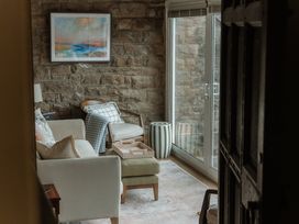 A living room with a sofa and armchair at Grey Walls in Glenridding