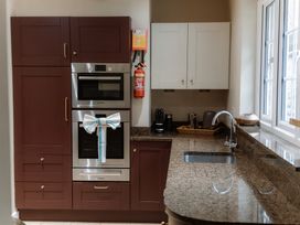 A kitchen with appliances and cabinets at Grey Walls in Glenridding