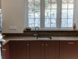 A kitchen with a sink and a granite countertop at Grey Walls in Glenridding