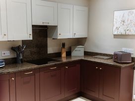 A kitchen with cabinets and a toaster at Grey Walls in Glenridding