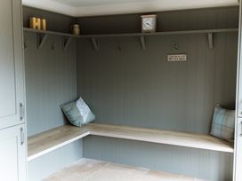 A mudroom with hooks and a bench at Grey Walls in Glenridding