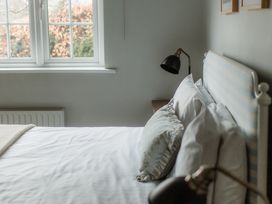 A bedroom with a bed and lamp at Grey Walls in Glenridding