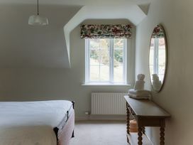 A bedroom with a bed and white towels on a table at Grey Walls in Glenridding