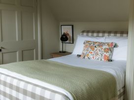 A bedroom with a bed and nightstand at Grey Walls in Glenridding