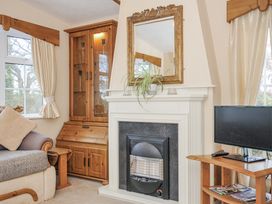 A living room with a fireplace and sofa at Little Malory in St Giles-On-The-Heath