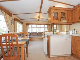A living room with a sofa and dining table at Little Malory in St Giles-On-The-Heath