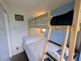 A bedroom with a wooden bunk bed and folded towels on a bed at Culver View in Sandown