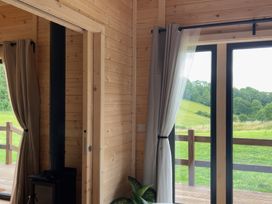 A room featuring a stove and window at Primrose, Higher Wambrook near Chard
