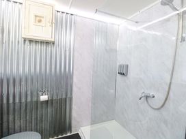 A bathroom with a shower and toilet at White Rabbit, Cross Lane, Eccles-On-Sea