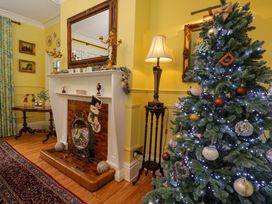 A living room with a Christmas tree and fireplace at White House