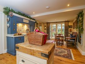 A kitchen with a wooden table and chairs at White House