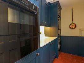 A laundry room with cabinets and appliances at White House 