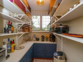 A kitchen with shelves of bottles and glasses at White House in 