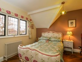 A bedroom with a bed and bedside table at White House